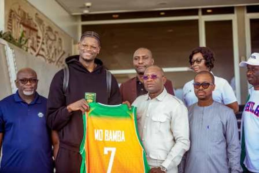 BASKET-BALL : MO BAMBA REÇOIT SON PASSEPORT IVOIRIEN DES MAINS DU MINISTRE DÉLÉGUÉ AUX SPORTS ET AU CADRE DE VIE, ADJE SILAS METCH.